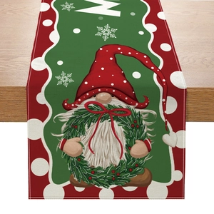 Christmas table runner with gnome print and red polka dots on wooden background