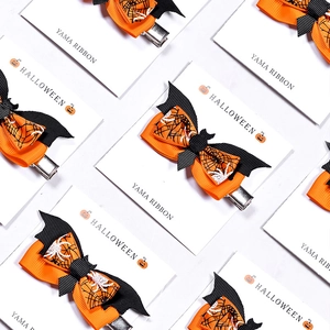Halloween orange and black ribbon bows with spider web and pumpkin patterns for decor