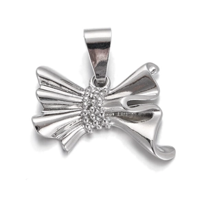 Close-up of a silver bow pendant with polished metal finish and center bead detail