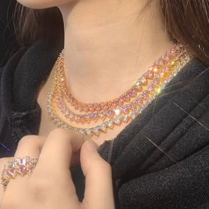 Three-layer heart necklace and matching ring set with pink and white gems in gold plating
