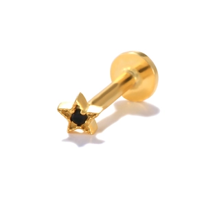 Detail of a gold S925 sterling silver star stud earring with a black gemstone inlay