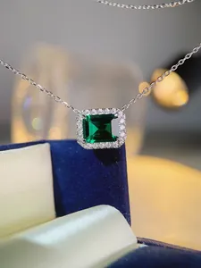 Close-up of S925 sterling silver emerald cut green gemstone pendant necklace in jewelry box
