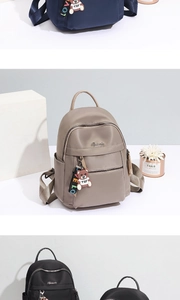 Three premium nylon backpacks in navy, beige, and black with cute bear charms