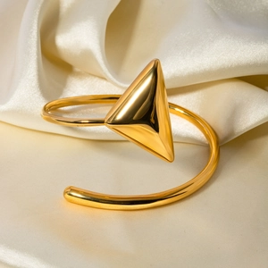 Detailed view of 18k gold plated stainless steel bracelet on elegant white silk background