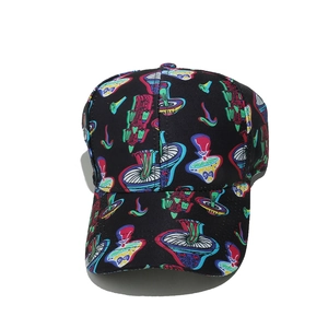 Close-up of colorful mushroom patterns and stitch details on black baseball cap