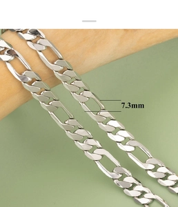 Detailed close-up showing the 7.3mm width measurement of the silver Figaro chain