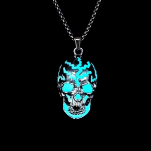 Detailed close-up of a silver skull pendant with blue glowing cracks and metal chain