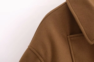 Detail shot of vintage brown wool jacket collar and professional shoulder stitching texture