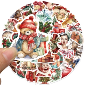 Close-up of vintage Christmas stickers featuring hand-held bears and retro festive designs