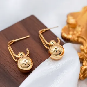 Polished 18k gold plated stainless steel U-shaped earrings with double ball pendants