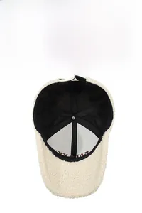 Detail view of teddy fleece baseball cap interior lining and adjustable metal buckle