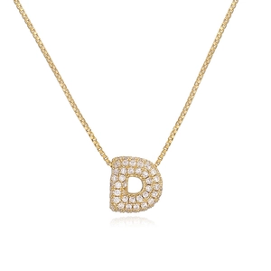 Close-up of golden letter D pendant featuring pavé-set crystals and a classic box chain