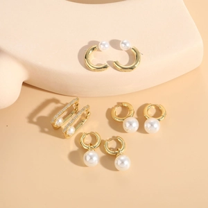 Close-up of four assorted 14K gold plated bohemian pearl earrings and zircon hoops