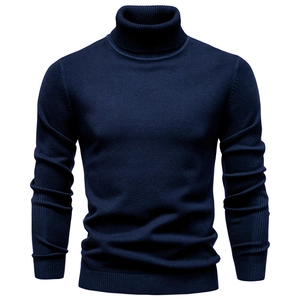 Close-up of navy blue men's turtleneck sweater showing fine knit texture and ribbed cuffs