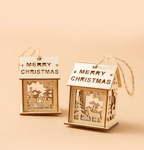 Detail of wooden Christmas house ornaments with laser-cut Merry Christmas engraving