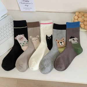 Detailed knit texture of 5-pack cartoon animal socks with lamb and bear motifs