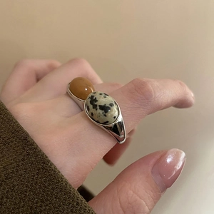 Silver open ring with oval amber and Dalmatian stone inlay in a retro aesthetic