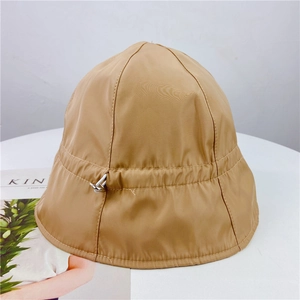 Detail of khaki bucket hat with adjustable elastic drawstring and silver metal toggle