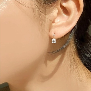Close-up of model wearing 925 sterling silver square zircon earrings with glossy finish
