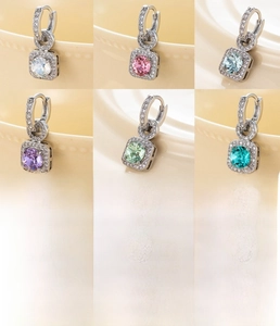 Macro shot of 10mm copper hoop earrings with large colorful cubic zirconia settings