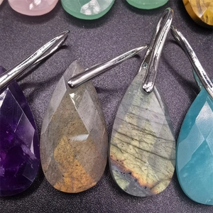 Macro detail showing multifaceted teardrop semi-precious stone pendants in various colors