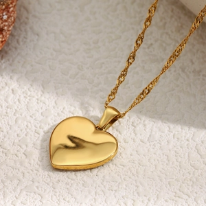Detailed macro of 18K gold plated heart pendant with a fine twisted rope chain necklace