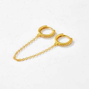 Detail of gold S925 sterling silver chain earrings with cubic zirconia for double piercings
