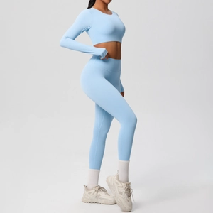 Light blue two-piece yoga set with long sleeve crop top and high waisted leggings