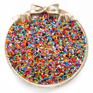 Colorful 2mm glass seed beads in a round tray for DIY jewelry making and crafts