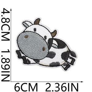 Detailed embroidery texture of a cute black and white cow patch with dimensions