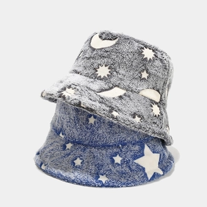 Close-up of blue and gray plush bucket hats featuring starry night sky patterns