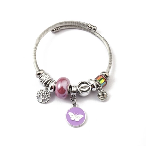 Detail of beaded charm bracelet with Tree of Life pendant and purple butterfly charm