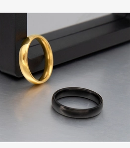 Detail view of 4mm gold and black mirror polished stainless steel minimalist rings