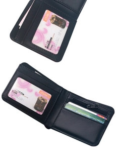 Detail view of the black leather wallet interior showing card slots and zipper pocket