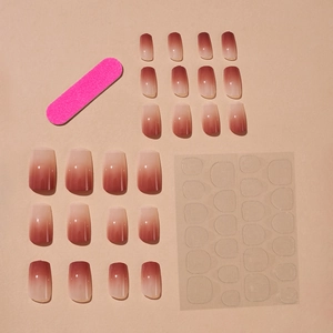 Long coffin blush gradient press-on nails with glossy finish and manicure tool kit