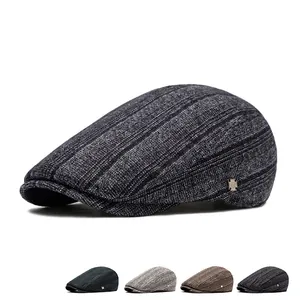 Classic striped vintage newsboy cap for men featuring a metallic side logo detail