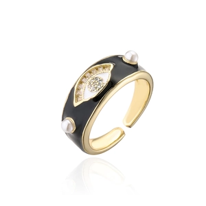 Detail of 18K gold plated evil eye ring with black enamel, zircon and white pearls