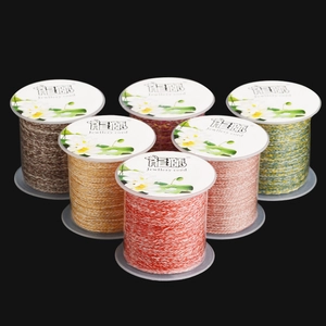 Three-strand braided cotton jewelry cord in various colors on transparent spools