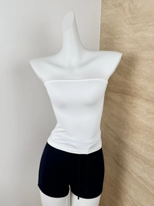 Detail of white ribbed bandeau top and black drawstring shorts on a mannequin