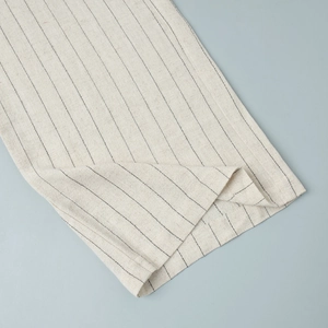 Close-up of the breathable striped cotton-linen fabric texture with neat edge stitching