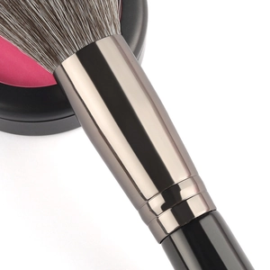 Contoured sculpting brush with ultra-soft grey bristles and metallic finish handle