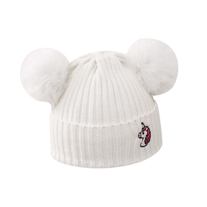 Winter knit hat for girls with white double pom-poms and unicorn embroidery detail