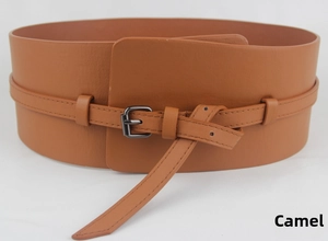Detail of camel wide corset belt with double-layer strap and dark metal buckle