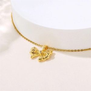 Elegant 18K gold bow necklace featuring sparkling zircon stones on a white background