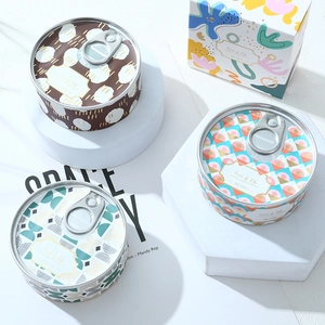Detailed view of 80g tin canned soy candles with geometric patterns and matching boxes