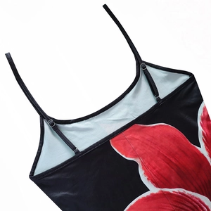 Detail of red floral print on black fabric with adjustable thin spaghetti straps