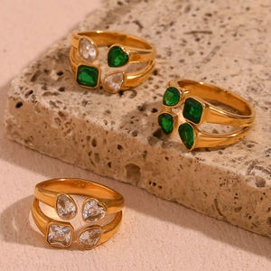 Macro view of 18K gold plated double-layered rings with square and teardrop stones