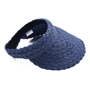 Detailed view of dark blue woven paper visor with 100% paper material label