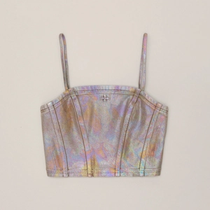 Detailed close-up of metallic holographic camisole with cross star hardware and seam lines