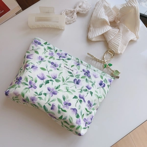 Floral cotton makeup bag with purple flower print and simple wish label on white surface